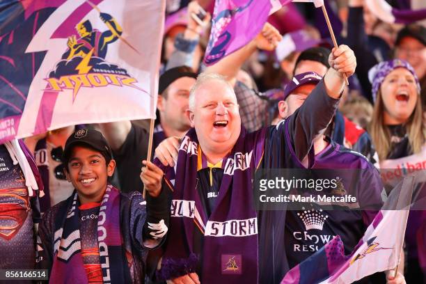 Storm fans celebrate a try during the 2017 NRL Grand Final match between the Melbourne Storm and the North Queensland Cowboys at ANZ Stadium on...