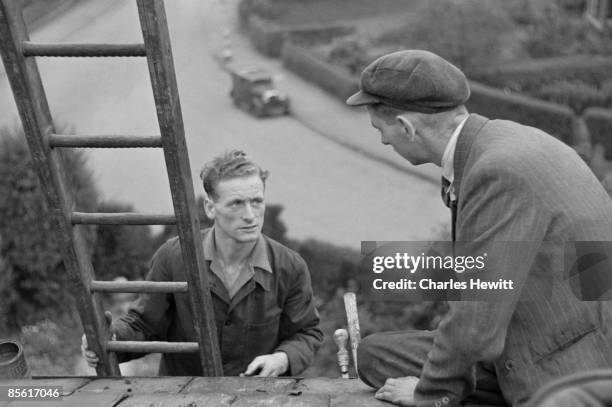 Preston North End footballer, Tom Finney, at work high up on a ladder, 2nd November 1946. Picture Post - 4243 - Finney: The Footballer Who Stops The...