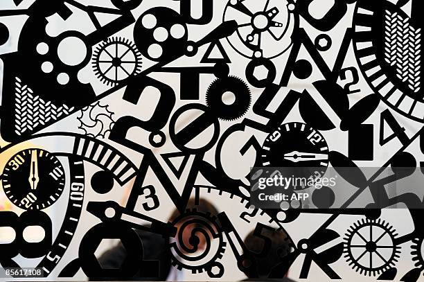 Man passes behind a decorative wall at the Baselworld 2009 watch and jewellery show on March 26, 2009 in Basel. The glittering watch and jewellery...