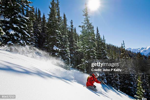 man skiing powder on aspen mountain - mt aspen stock pictures, royalty-free photos & images