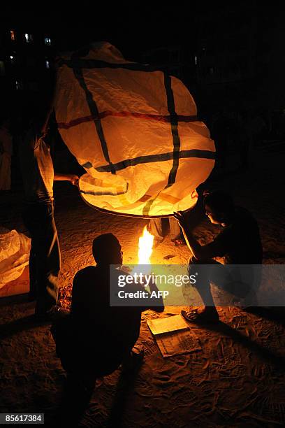 Bangladeshis prepare a hot-air paper balloon as they celebrate Independence Day in Dhaka on March 26, 2009. Bangladesh is celebrating the 38th...