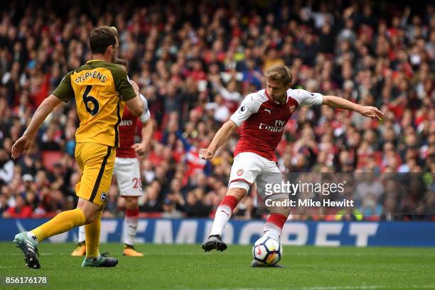 Nacho Monreal of Arsenal scores his sides first goal during the Premier League match between Arsenal and Brighton and Hove Albion at Emirates Stadium...