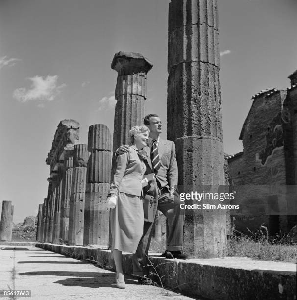 Actors Joseph Cotten and Joan Fontaine visit the ancient Roman city of Pompeii in Italy, during the location filming of 'September Affair', August...
