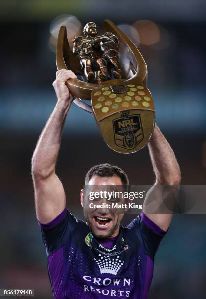 Cameron Smith of the Storm celebrates and holds aloft the NRL Premiership trophy after victory in the 2017 NRL Grand Final match between the...