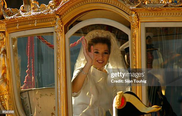 Dutch Crown Princess Maxima Zorreguieta waves from the Golden Coach after her wedding to Crown Prince Willem Alexander February 2, 2002 outside the...