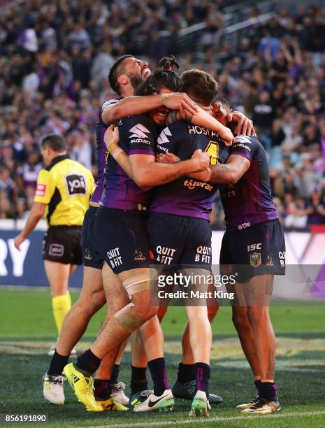 Curtis Scott of the Storm celebrates with team mates after scoring a try during the 2017 NRL Grand Final match between the Melbourne Storm and the...