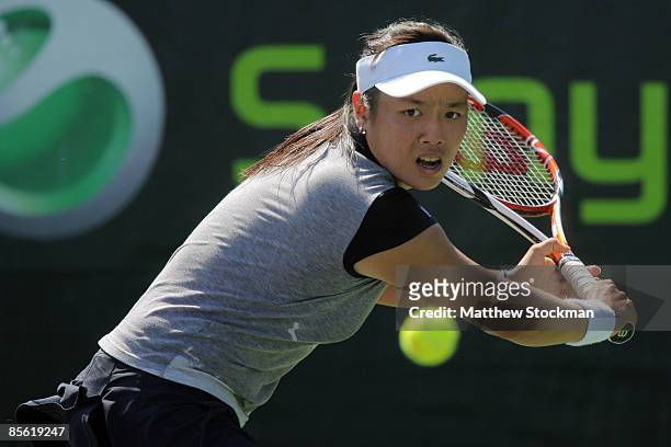 Yung-Jan Chan of Chinese Taipei returns a shot against Ekaterina Makarova of Russia during day four of the Sony Ericsson Open at the Crandon Park...