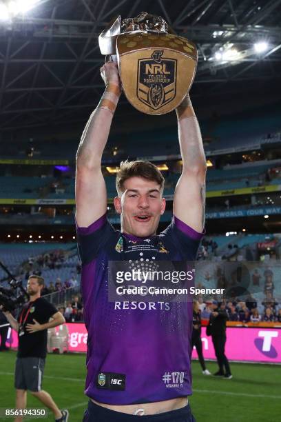 Curtis Scott of the Storm holds aloft the Provan-Summons Trophy after winning the 2017 NRL Grand Final match between the Melbourne Storm and the...