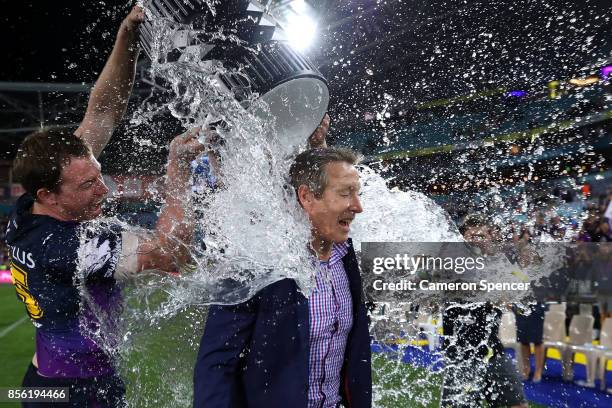 Storm coach Craig Bellamy is drenched with water after winning the 2017 NRL Grand Final match between the Melbourne Storm and the North Queensland...