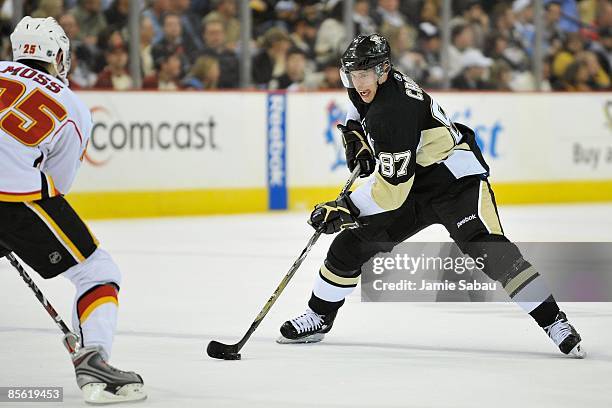 Forward Sidney Crosby of the Pittsburgh Penguins skates with the puck against the Calgary Flames on March 25, 2009 at Mellon Arena in Pittsburgh,...