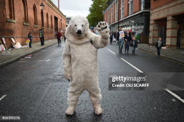 Protester in a polar bear costume takes part in an anti-austerity demonstration organised by The People's Assembly in Manchester to coincide with the...