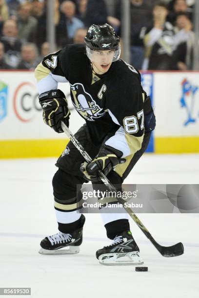 Forward Sidney Crosby of the Pittsburgh Penguins skates with the puck against the Calgary Flames on March 25, 2009 at Mellon Arena in Pittsburgh,...