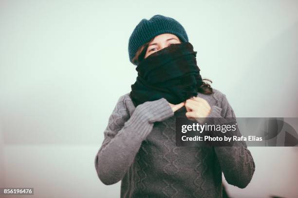 pretty woman in winter clothes - cold temperature inside stock pictures, royalty-free photos & images