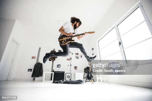 guitarist jumping - rock musician stock pictures, royalty-free photos & images