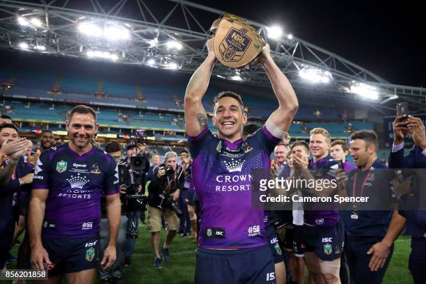 Billy Slater of the Storm walks off the field with team mates Cameron Smith and and Cooper Cronk during the 2017 NRL Grand Final match between the...