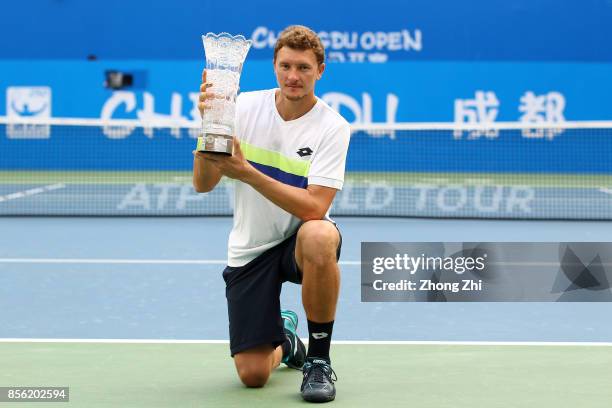 Denis Istomin of Uzbekistan celebrates with trophy after Marcos Baghdatis of Cyprus retired from the men's singles final on Day 7 of 2017 ATP Chengdu...