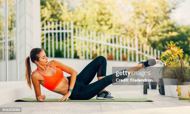 frau auf einer veranda ausübung - inner thigh workout stock-fotos und bilder
