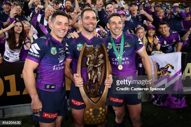 Cooper Cronk, Cameron Smith and Billy Slater of the Storm pose with the Provan-Summons Trophy after winning the 2017 NRL Grand Final match between...