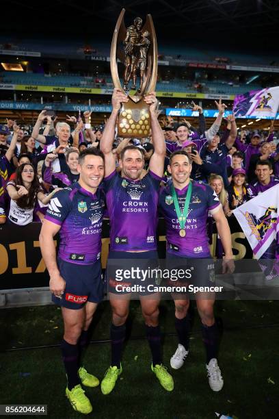 Cooper Cronk, Cameron Smith and Billy Slater of the Storm pose with the Provan-Summons Trophy after winning the 2017 NRL Grand Final match between...