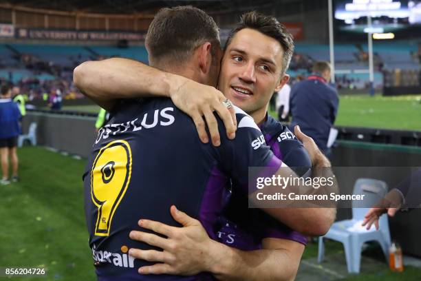 Cooper Cronk of the Storm celebrates with Cameron Smith after winning the 2017 NRL Grand Final match between the Melbourne Storm and the North...