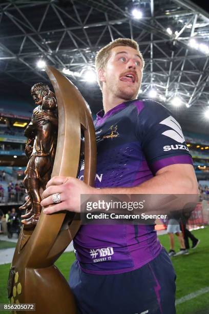 Cameron Munster of the Storm holds aloft the Provan-Summons Trophy after winning the 2017 NRL Grand Final match between the Melbourne Storm and the...