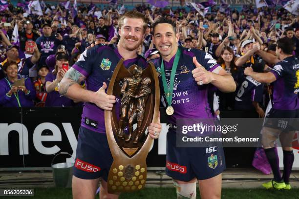 Cameron Munster of the Storm and Billy Slater of the Storm pose with the Provan-Summons Trophy after winning the 2017 NRL Grand Final match between...