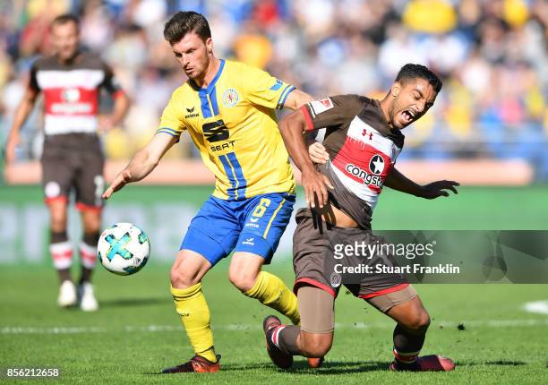 Quirin Moll of Braunschweig is challenged by Sami Allagui of St. Pauli during the Second Bundesliga match between Eintracht Braunschweig and FC St....