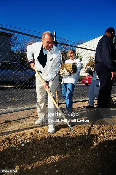 Abe Pollin, owner of the Washington Wizards rakes dirt during a Washington Wizards community event during the 1999 season in Washington D.C. NOTE TO...