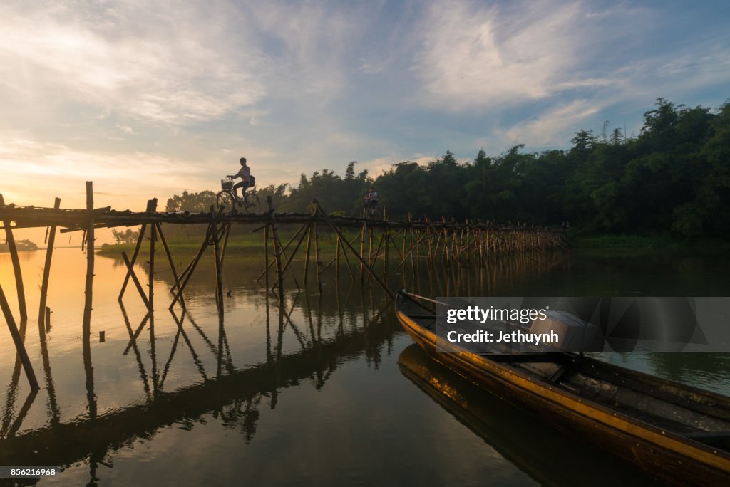 People moving at Bamboo bridge at countryside Quang Ngai Vietnam in the early morning
