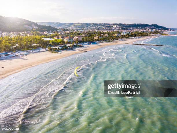 kite surfing alone on the beach - adriatic sea italy stock pictures, royalty-free photos & images