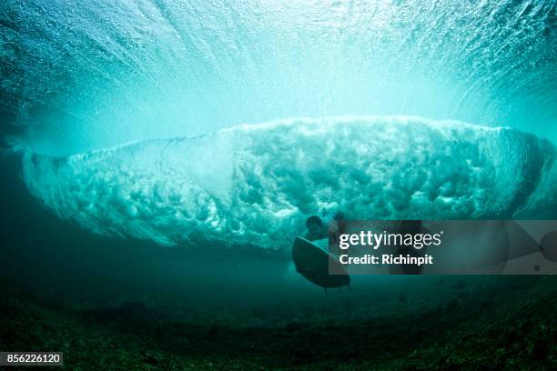 head on duck dive - surfer under wave stock pictures, royalty-free photos & images