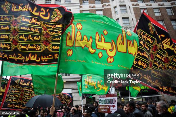 Protesters wave flags ahead of the annual Ashura march in Marble Arch on October 1, 2017 in London, England. Hundreds of protesters march through...
