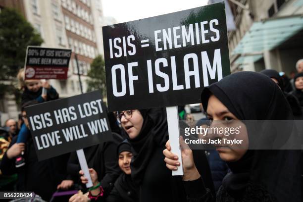 Protesters hold placards during the annual Ashura march in Marble Arch on October 1, 2017 in London, England. Hundreds of protesters march through...