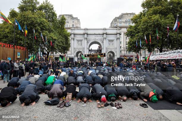 Muslims prey ahead of the annual Ashura march in Marble Arch on October 1, 2017 in London, England. Hundreds of protesters march through London today...