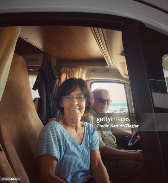 senior couple traveling in camper, smiling - portrait of a camper stock pictures, royalty-free photos & images