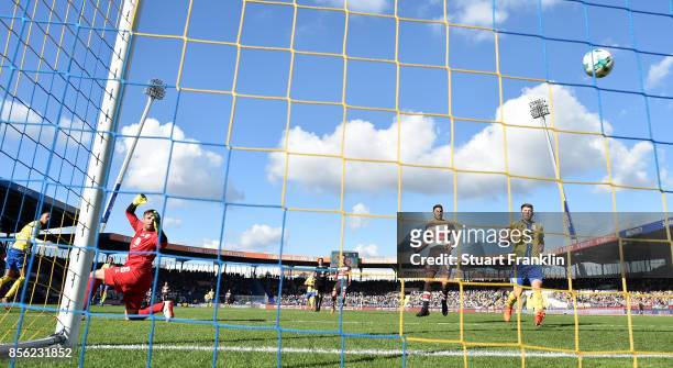 Christopher Buchtmann of St. Pauli chips the ball past Jasmin Fejzic of Braunschweig to score his goal during the Second Bundesliga match between...