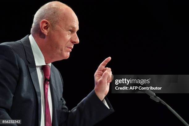 Britain's First Secretary of State and Minister for the Cabinet Office, Damian Green addresses the delegates on the first day of the Conservative...