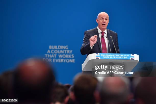 Britain's First Secretary of State and Minister for the Cabinet Office, Damian Green addresses the delegates on the first day of the Conservative...