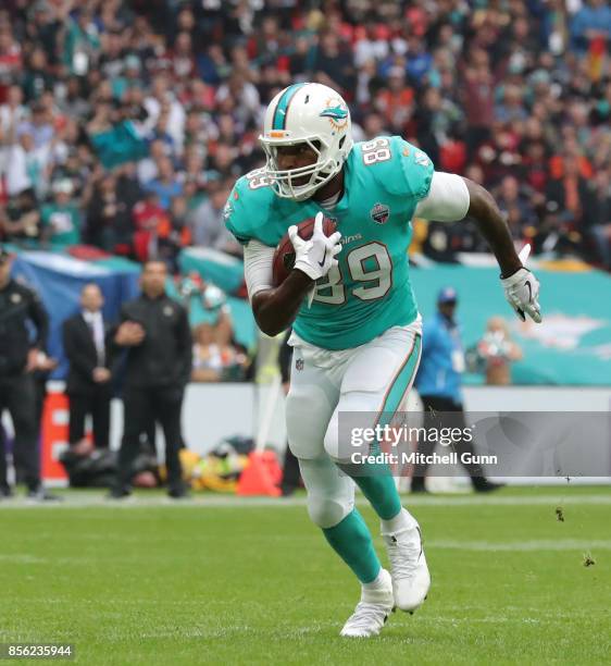 Miami Dolphins tight end Julius Thomas runs with the ball during the NFL match between the Miami Dolphins and the New Orleans Saints at Wembley...