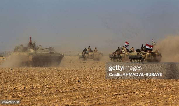 Iraqi forces and fighters from the Hashed al-Shaabi advance towards the Islamic State group's stronghold of Hawija on October 1, 2017 in their...