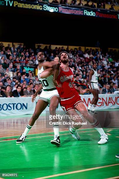 Carr of the Boston Celtics fights for position against Dave Corzine of the Chicago Bulls during a game played in 1982 at the Boston Garden in Boston,...