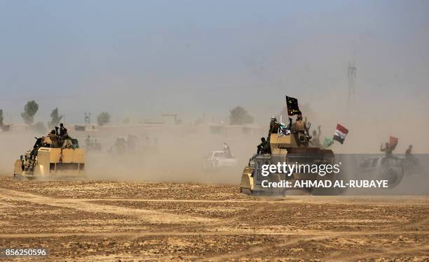 Iraqi forces and fighters from the Hashed al-Shaabi advance towards the Islamic State group's stronghold of Hawija on October 1, 2017 in their...