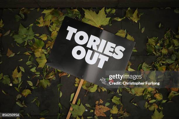 Tories Out' sign is left on the ground as anti-Brexit and anti-austerity activists take part in protests as the Conservative party annual conference...