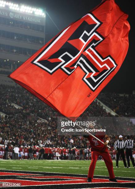 Texas Tech cheerleader waves the a Double T flag after a touchdown during the Texas Tech Raider's 41-34 loss to the Oklahoma State Cowboys on...