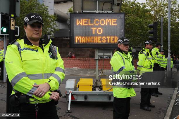 Police stand guard as anti-Brexit and anti-austerity activists take part in protests as the Conservative party annual conference gets underway at...