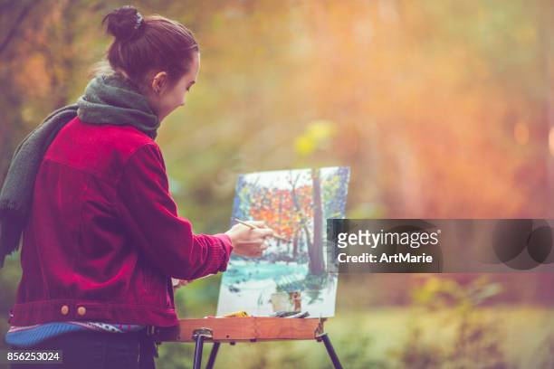 female artist painting outdoors - oil painting people stock pictures, royalty-free photos & images