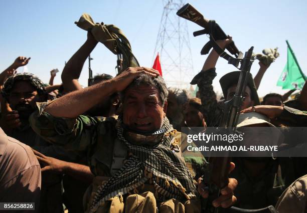 Iraqi fighters from the Hashed al-Shaabi take part in Ashura commemorations that mark the killing of Imam Hussein, one of Shiite Islam's most revered...