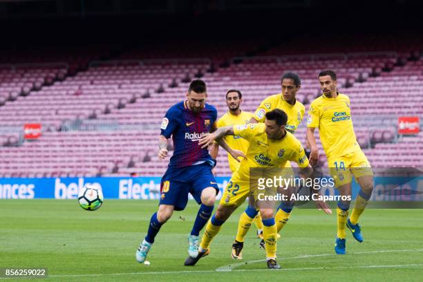 Lionel Messi of FC Barcelona battles for the ball with Ximo Navarro of UD Las Palmas during the La Liga match between Barcelona and Las Palmas at...