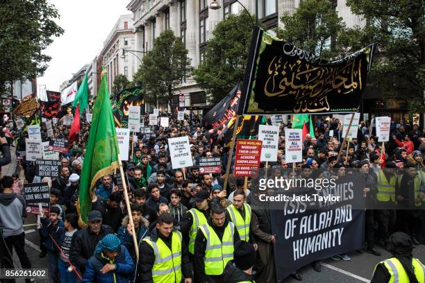 Protesters holding flags and placards demonstrate along Oxford Street during the annual Ashura march in Marble Arch on October 1, 2017 in London,...