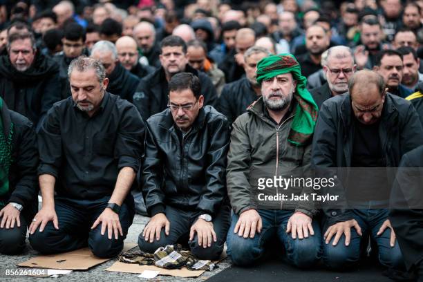 Muslims prey ahead of the annual Ashura march in Marble Arch on October 1, 2017 in London, England. Thousands of protesters march through London...